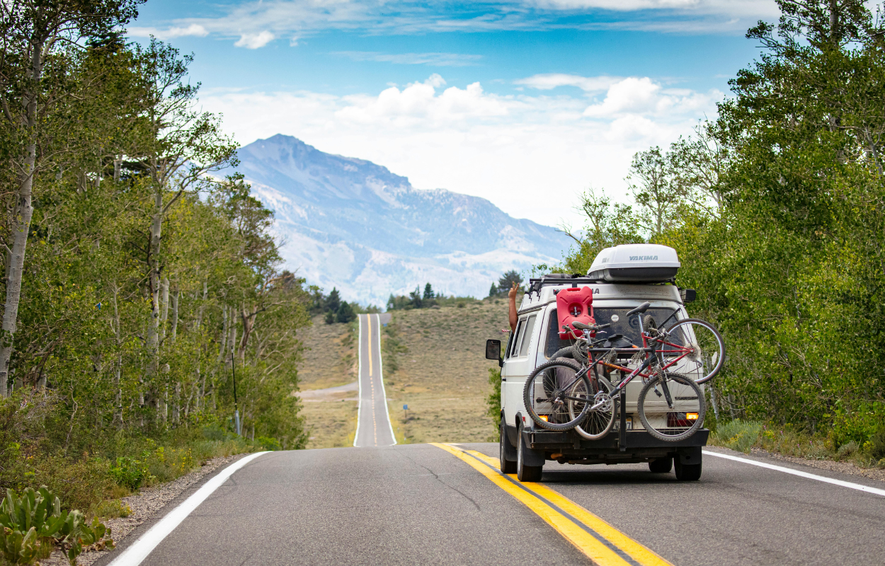 van on road with mountain in background